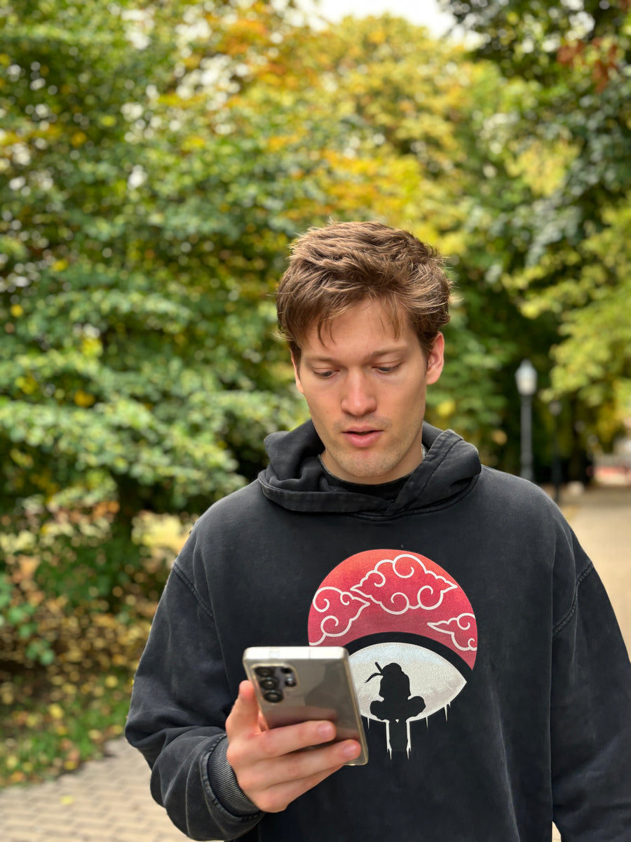 A fan wearing the UCHIHA ITACHI HOODIE