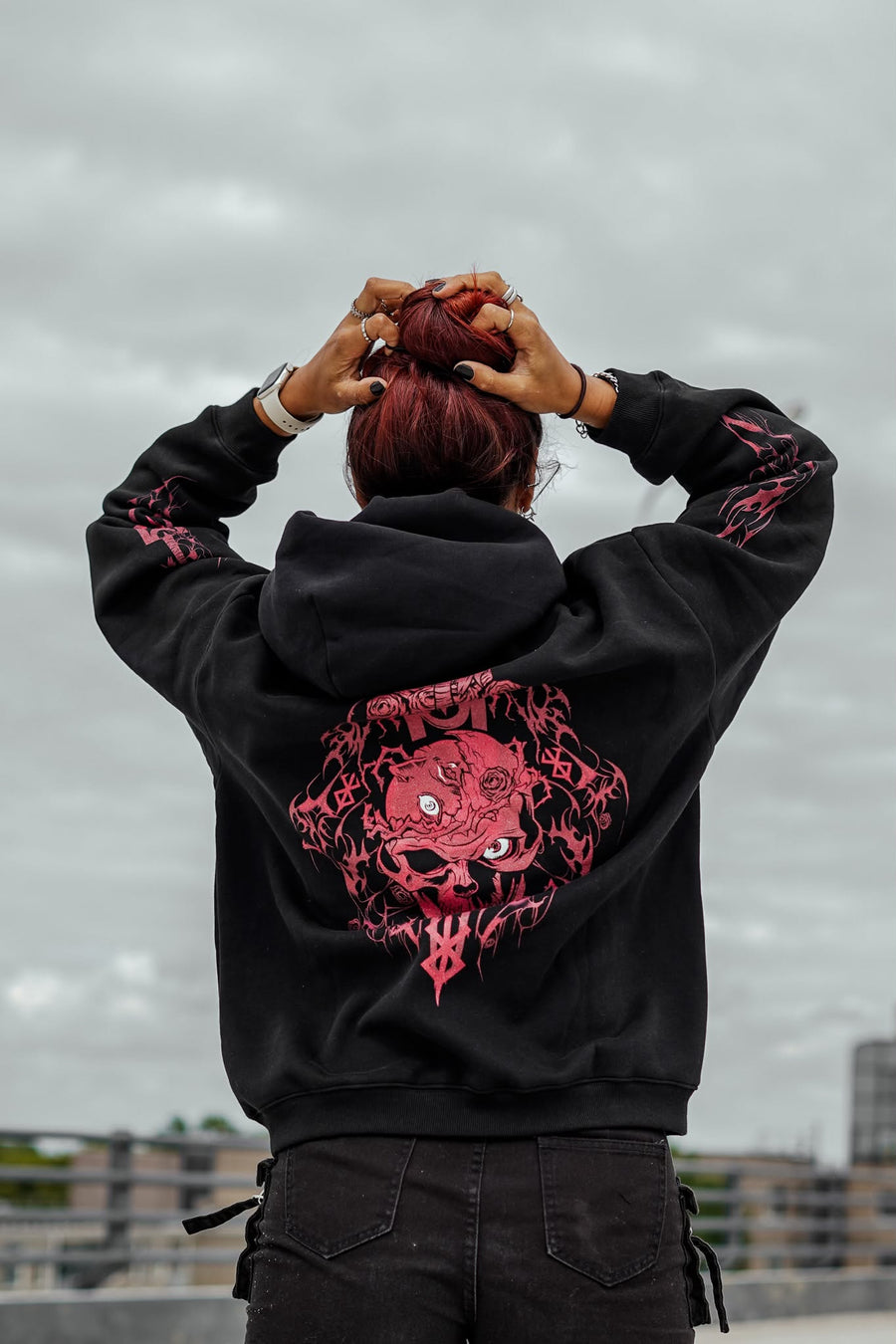 A fan wearing the Berserk Brand of Sacrifice Guts Anime Hoodie
